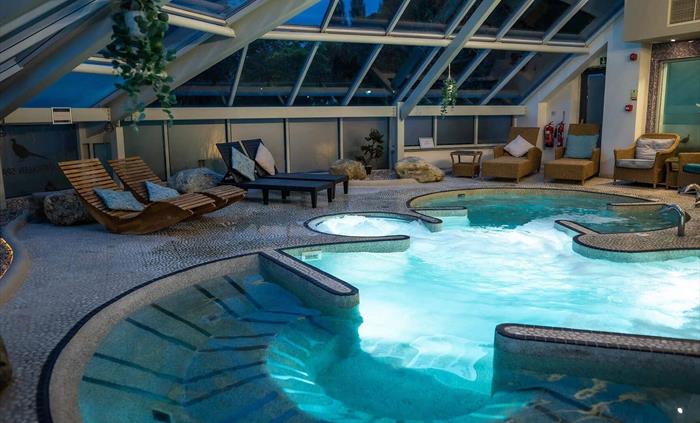 Spa area at Wild Pheasant Hotel & Spa featuring a wellness pool with bubbling water in the evening.